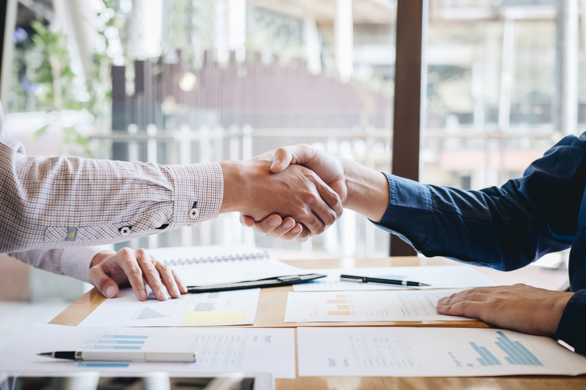 Finishing up a conversation after collaboration, handshake of two business people after contract agreement to become a partner, collaborative teamwork
